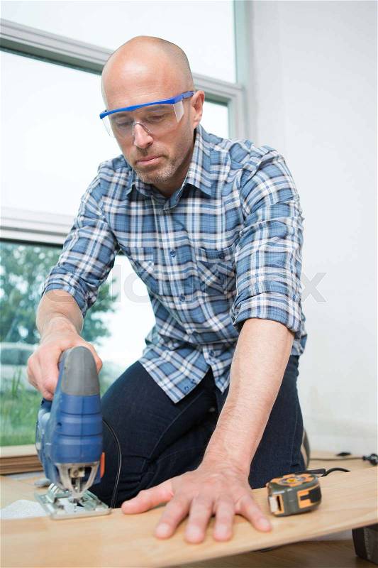 Man using an electric grinder machine, stock photo