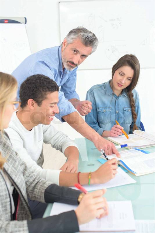 Adult student in business class with teacher, stock photo