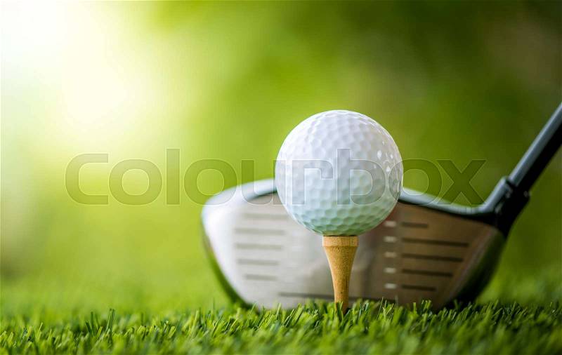 Teeing off with golf club and golf ball, stock photo