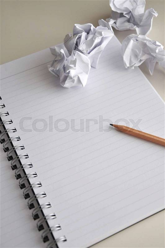 Pencil point to blank page of notebook with crumple paper, stock photo