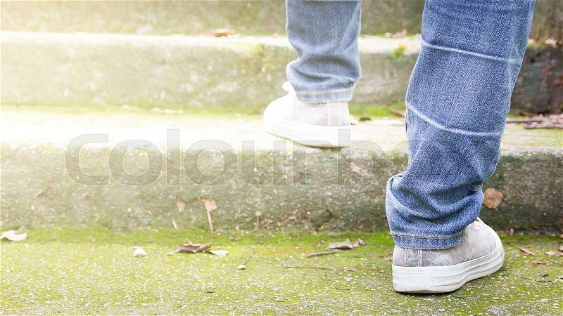 Feet Sneakers And Jeans Walking On Staircase Outdoor With Autumn Season Nature On Background Lifestyle Fashion Trendy Style, Walking In The Park Outdoors. , stock photo