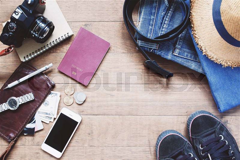 Flat lay of Treveler\'s items, Essential vacation accessories of young smart traveler, Travel concept on wood background, stock photo