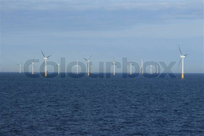 With the ferry along the wind farm in the North Sea between IJmuiden (The Netherlands) and Newcastle (Great Britain) at sunrise in the summer, stock photo
