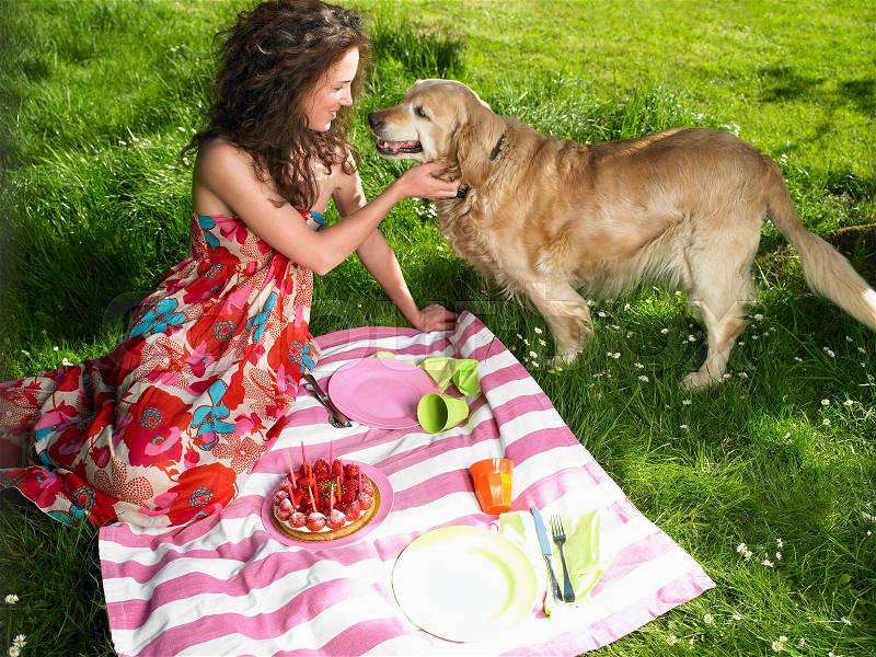 Woman having a picnic in the garden, stock photo