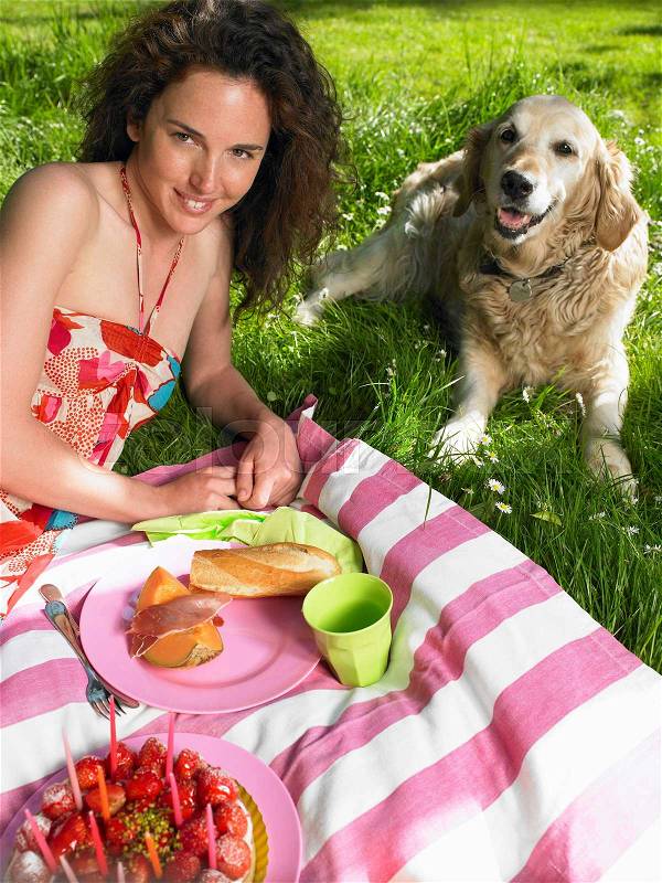 Woman having a picnic in the garden, stock photo