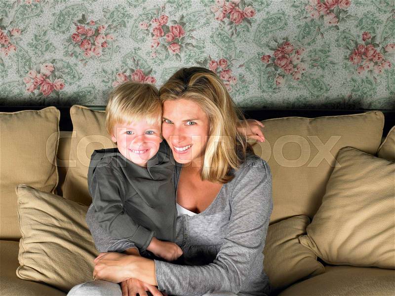 Mother and son watching television, stock photo