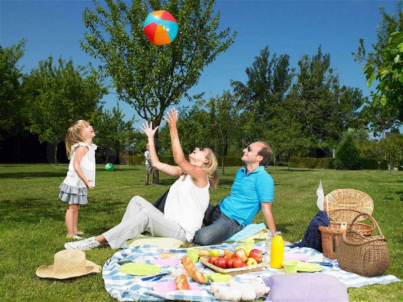 Family having a picnic in the garden, stock photo