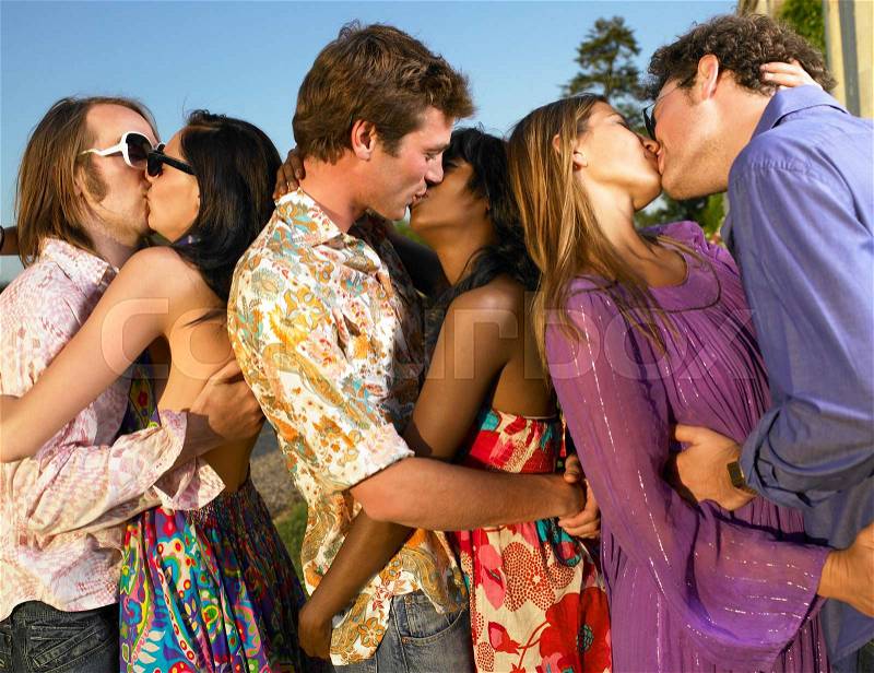 Three couples kissing at sunset, stock photo
