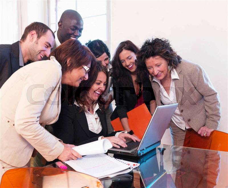 Smiling co-workers in office, stock photo