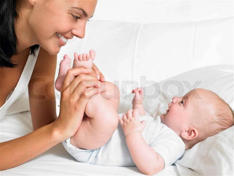 Mother kissing her new-born baby\'s feet, stock photo