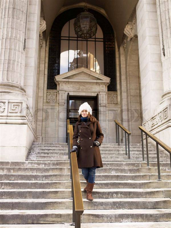 Woman on steps of New York Library, stock photo
