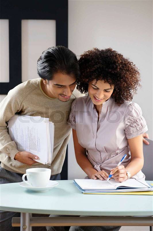 Man and woman in office cafe, stock photo