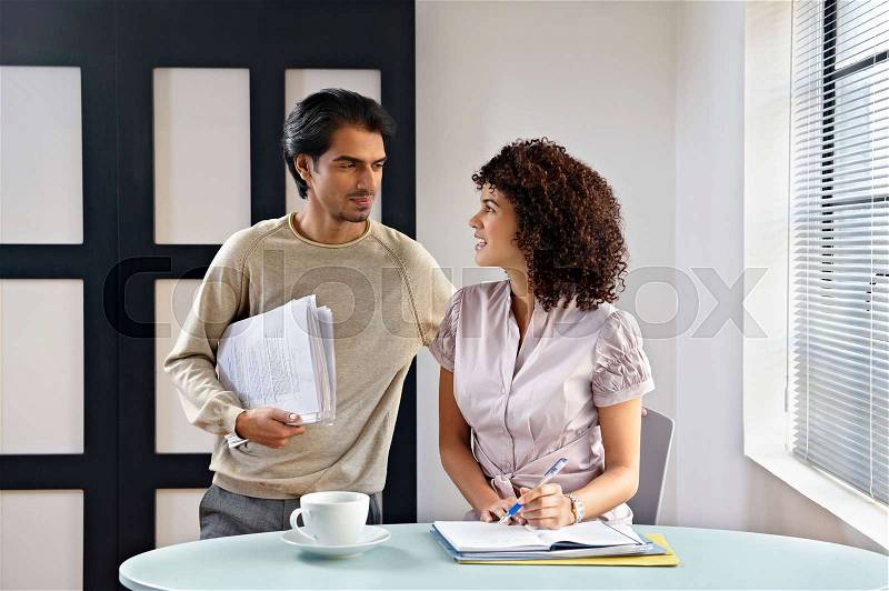 Man and woman in office cafe, stock photo