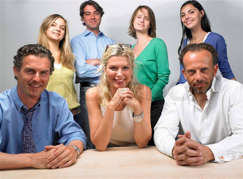 Happy coworkers looking at camera, stock photo