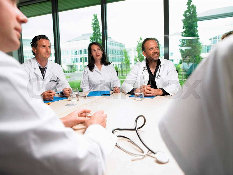 Doctors around a table, stock photo