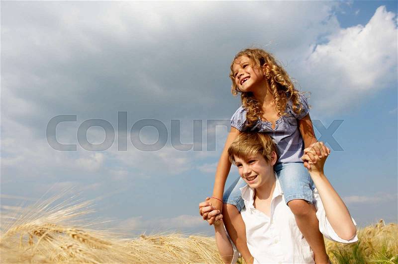 Brother and sister in a wheat field, stock photo