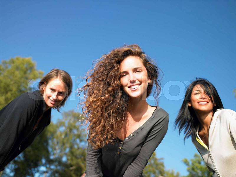 Women looking into the camera, smiling, stock photo
