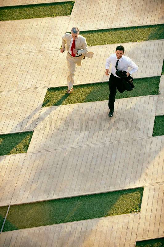 Two business men running, stock photo
