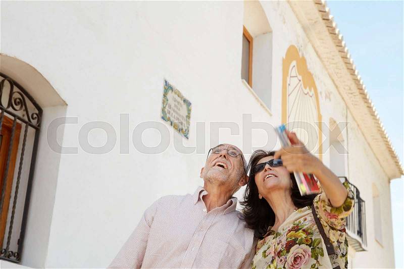 Older couple looking at attractions, stock photo