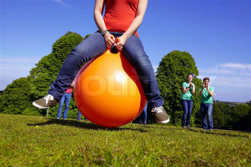 Teams racing on exercises balls, stock photo