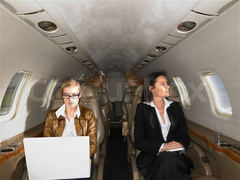 Two women in a private jet, stock photo