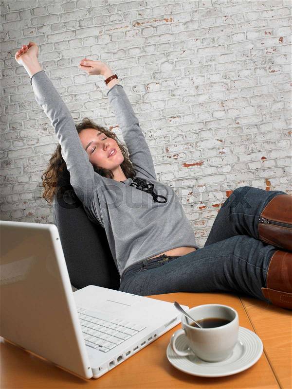 Businesswoman stretching with feet up, stock photo