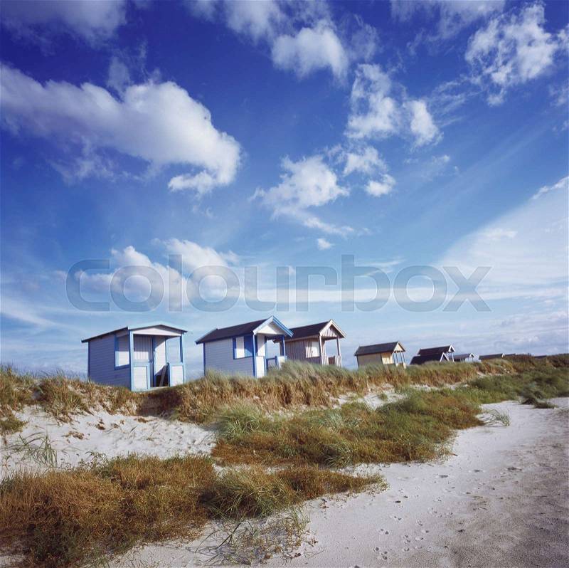 A row of changing houses near a beach, stock photo