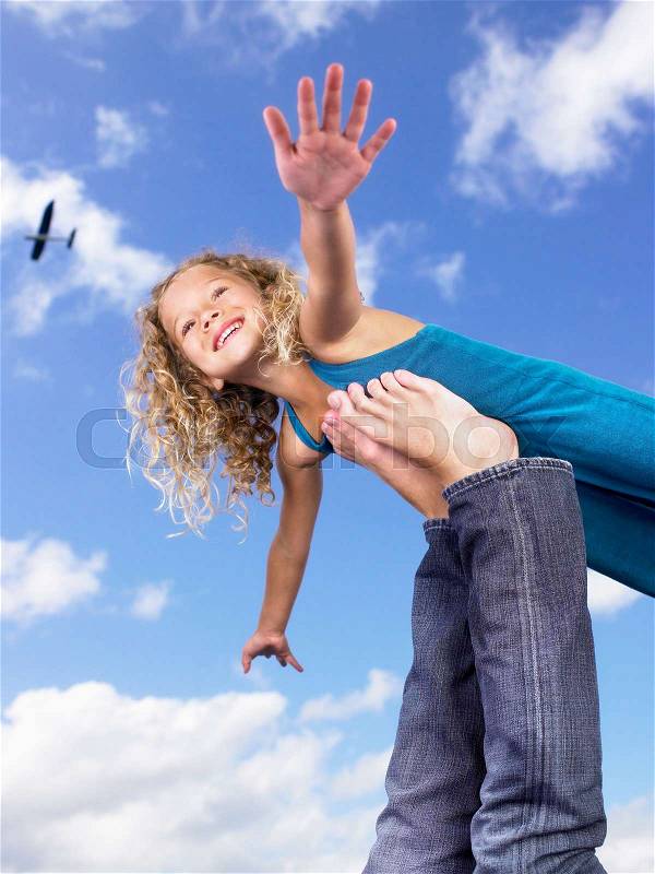 Young girl swirling feet in the air, stock photo