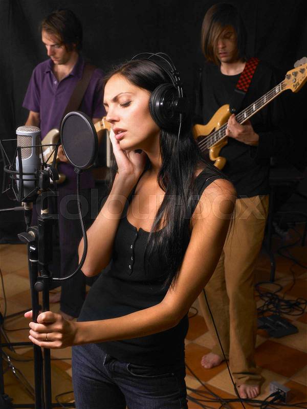 Woman singing in a band, stock photo