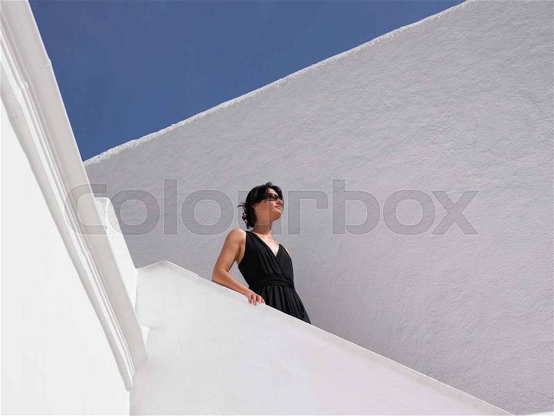 Woman climbing down the stairs, stock photo