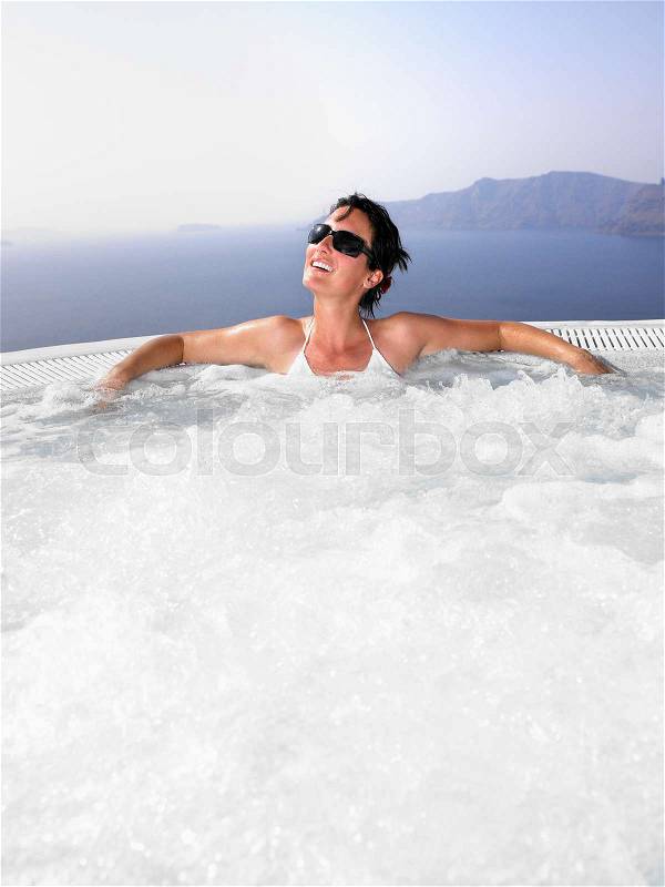 Woman in hot tub, stock photo