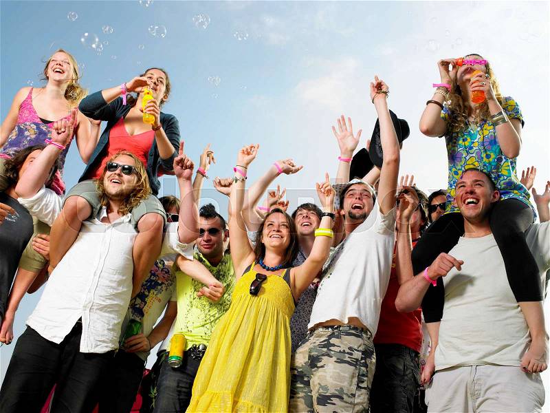 Crowd of young people cheering, stock photo