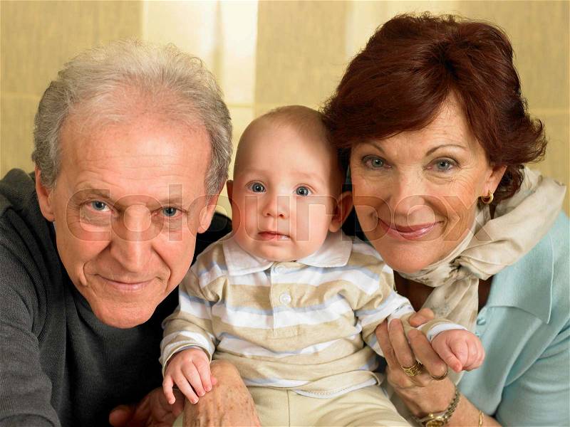 Senior grandparents with baby grandson, stock photo