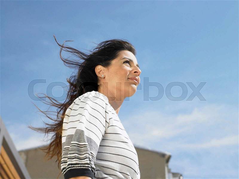 Low angle portrait of woman against sky, Alicante, Spain,, stock photo