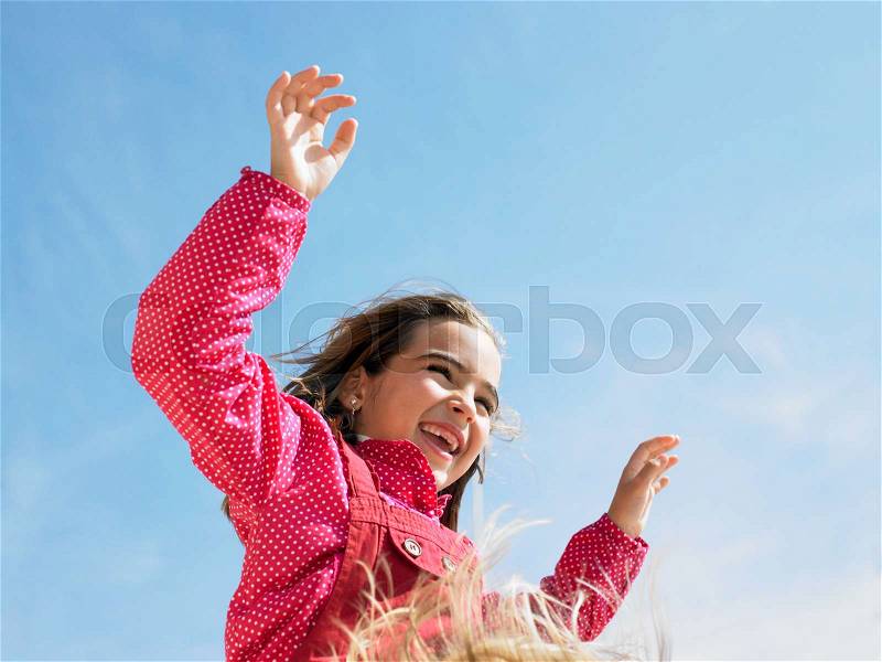 Young girl with arms on shoulders, stock photo