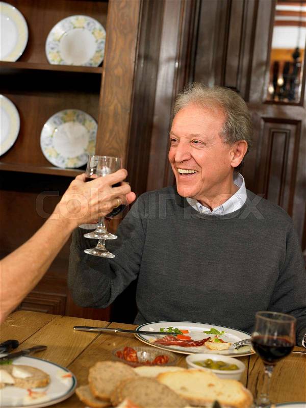Senior Adult man toasting wine, stock photo