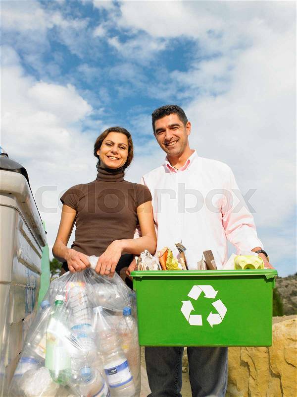 Couple posing with recycling objects, stock photo