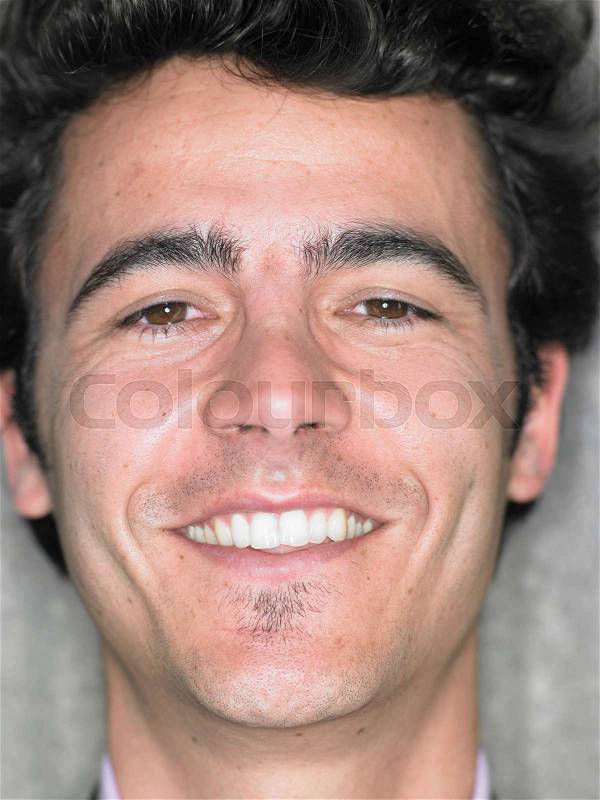 Close up portrait of young man smiling, stock photo