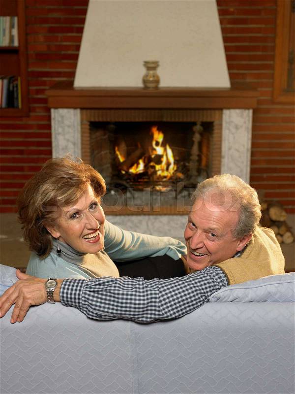 Senior couple relaxing in living room, stock photo