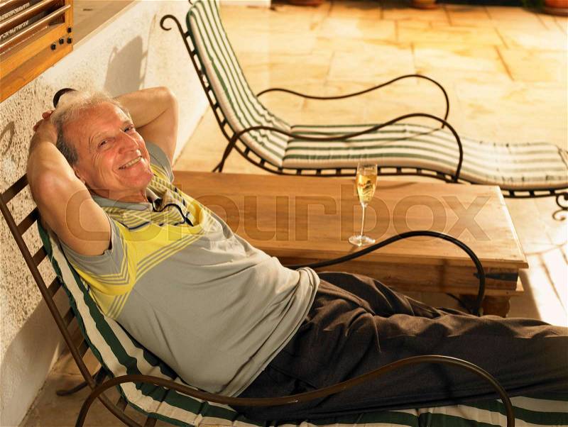 Senior Adult man lying on sun lounger, stock photo