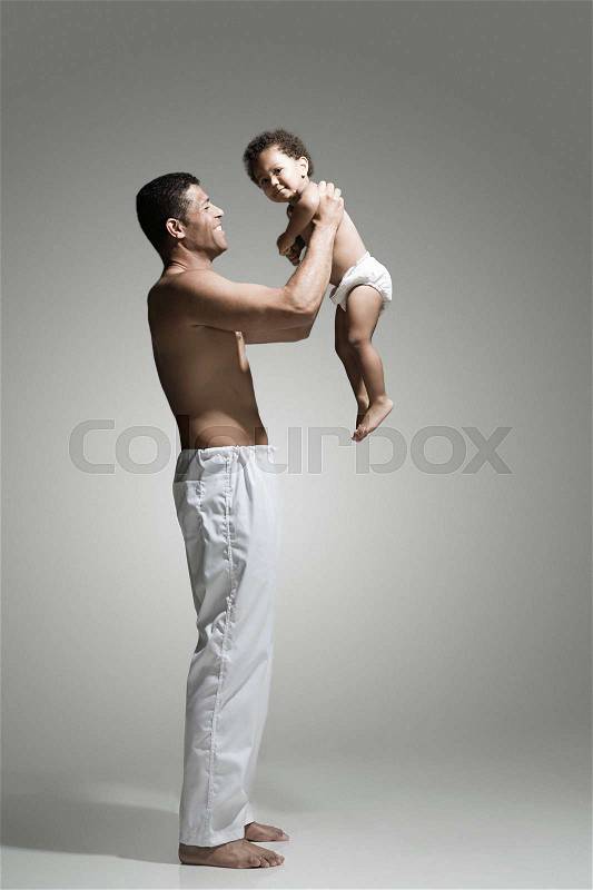 Father lifting his son, stock photo