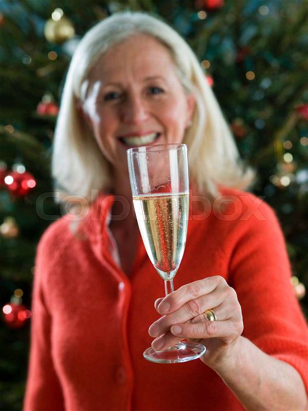 Woman holding a champagne flute, stock photo