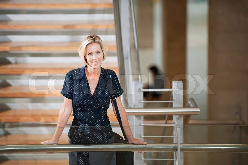 Businesswoman on stairwell, stock photo