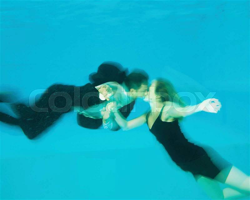 A couple kissing in a swimming pool, stock photo
