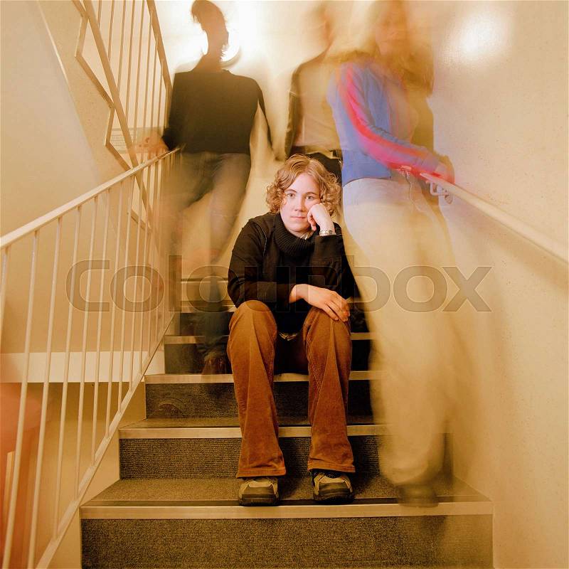 Student sitting on steps, stock photo