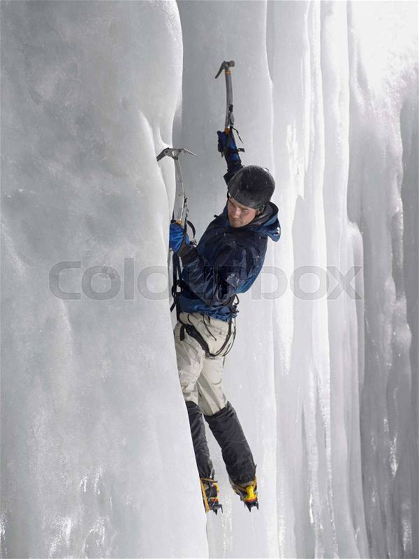 Man ice climbing, stock photo