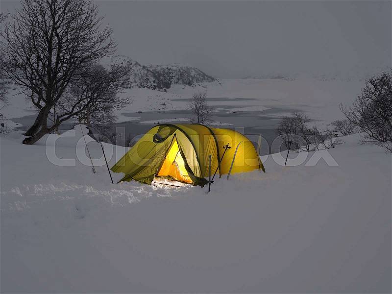Yellow tent in the snow, stock photo