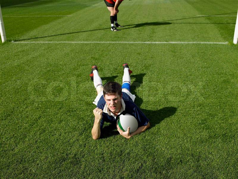 Rugby player scoring a try, stock photo