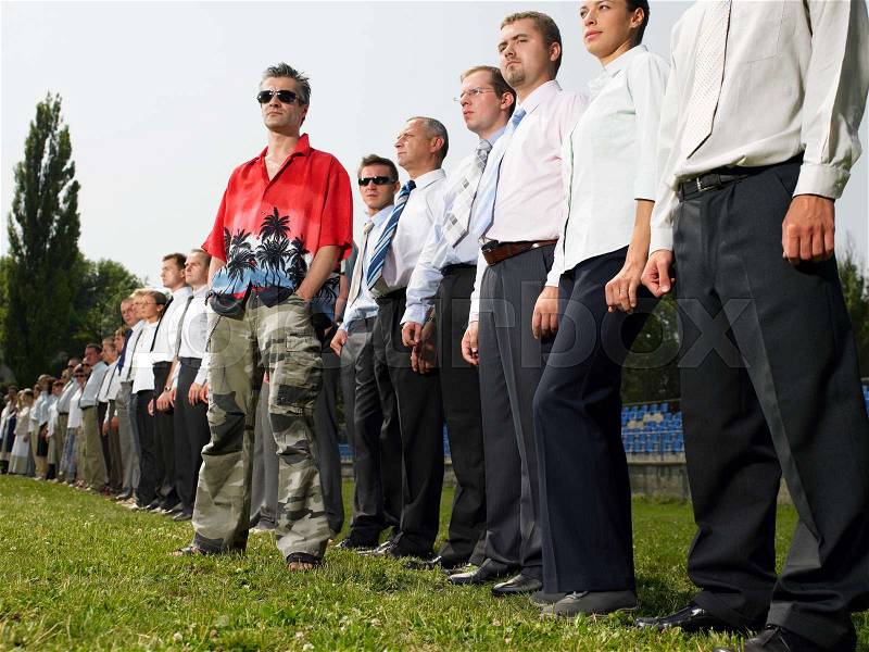 Man standing out from the crowd, stock photo