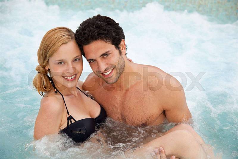 Young couple in hot tub, portrait, stock photo